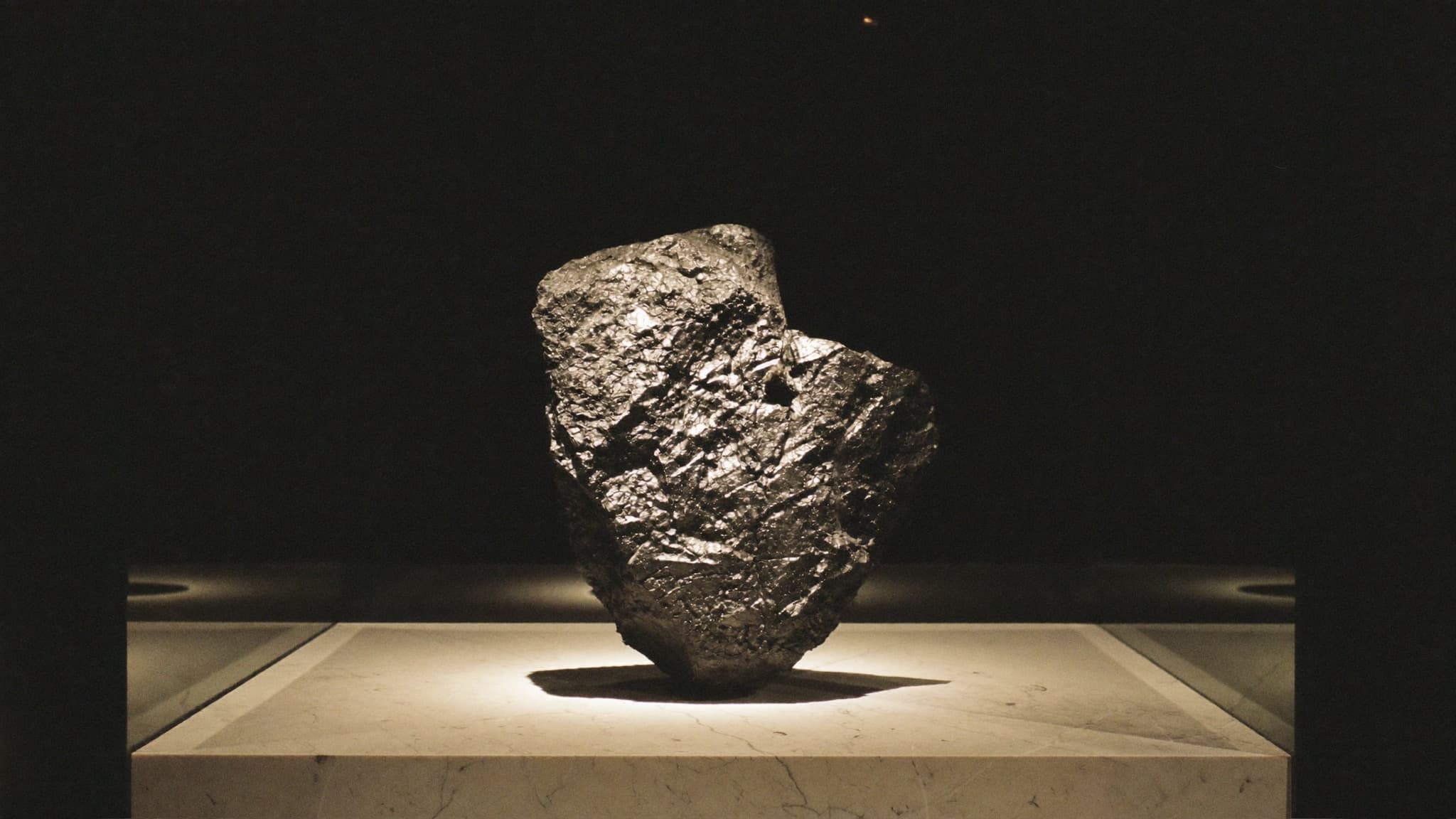 A lump of black coal displayed in a glass museum case under a spotlight, a nod to Newcastle as Australia's most expensive coal town.
